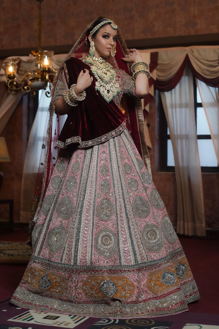 A Woman In Pink And Red Saree