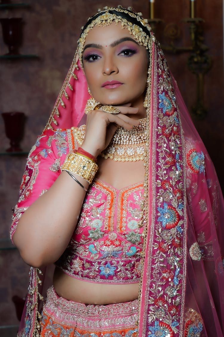 A Woman In Pink And Red Saree