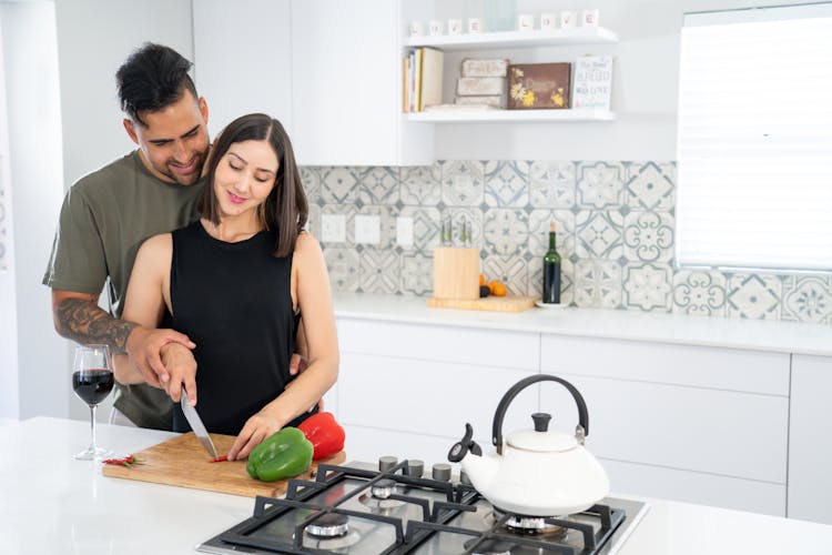 A Couple Cooking In The Kitchen