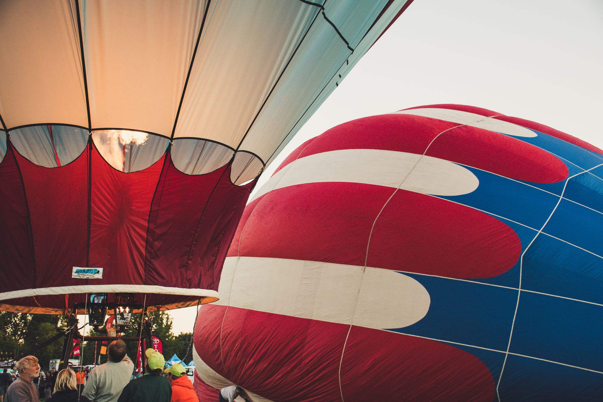 Vibrant hot air balloons being inflated for a scenic outdoor flight adventure.