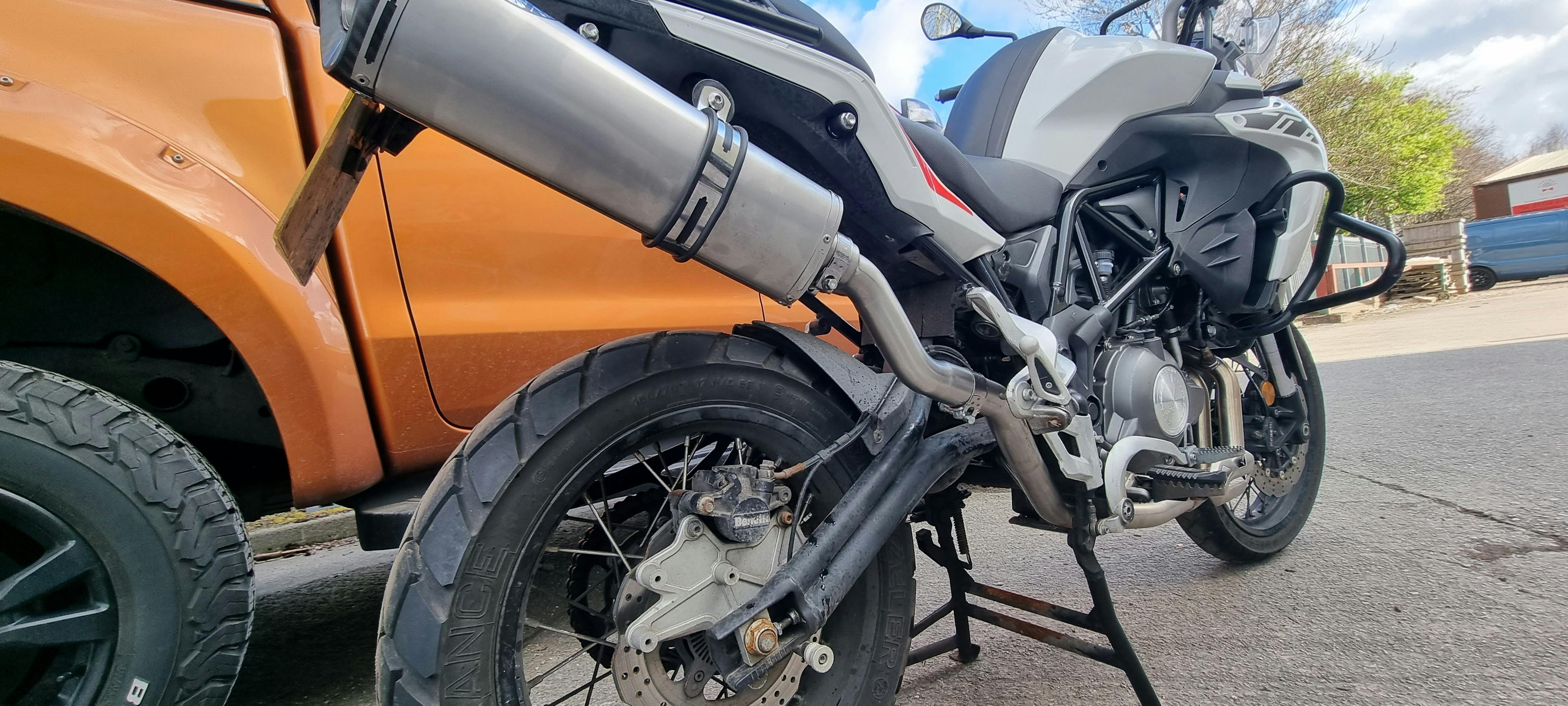 Scoreboard at a cricket ground showing team totals and wickets