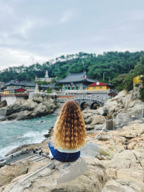 Photo of Woman sitting on a Rock