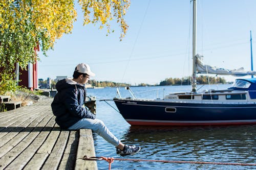 Person Sitting On Dock