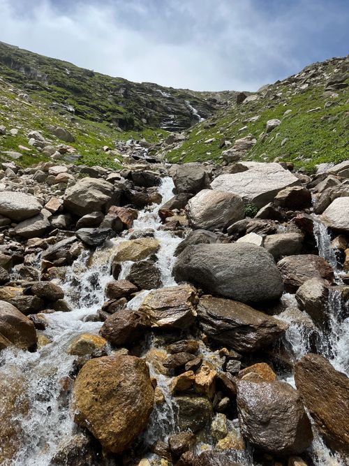 Free Tranquil mountain stream cascading over rocks in Burwa, HP, India. Stock Photo