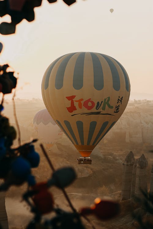 A Hot Air Balloons Flying Under the Clear Sky