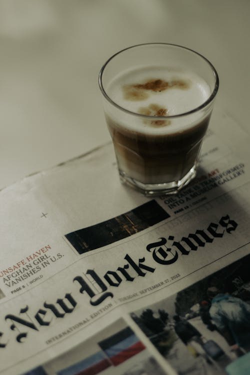 Free A Glass of Coffee on a Newspaper  Stock Photo
