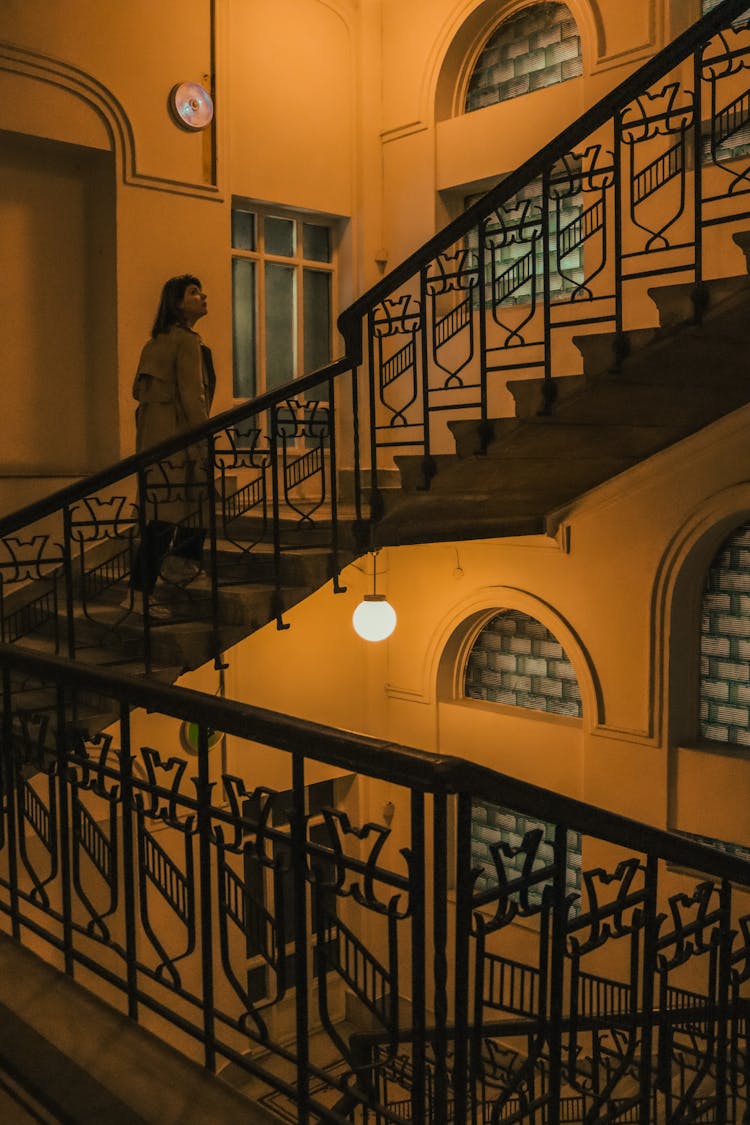 Woman Walking On Stairs In Old Building