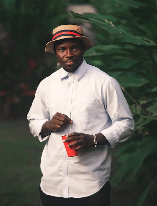 Man in White Shirt and Hat