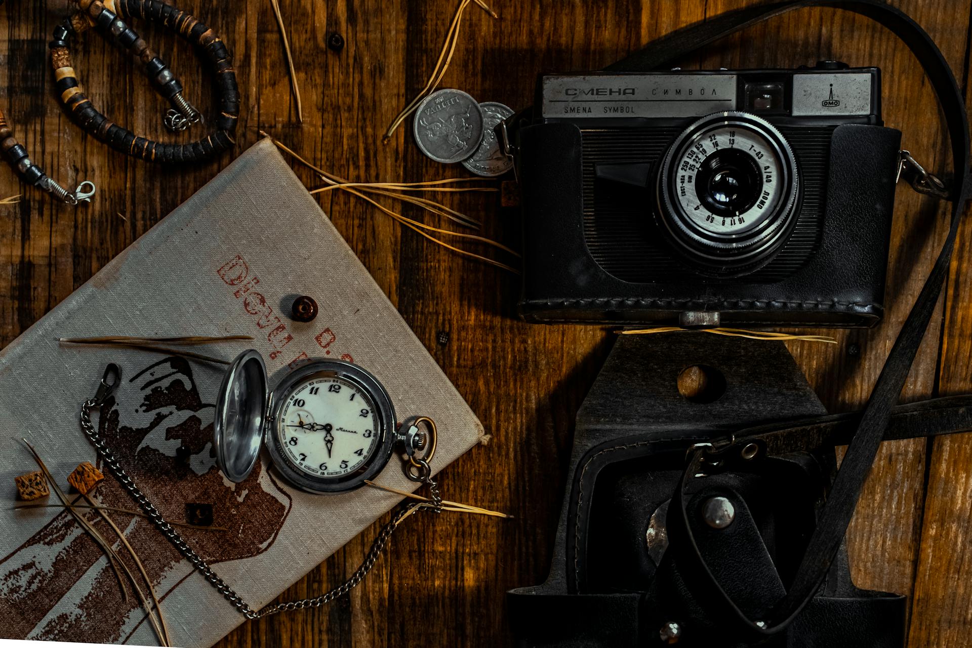 Black and Silver Camera on Brown Wooden Table