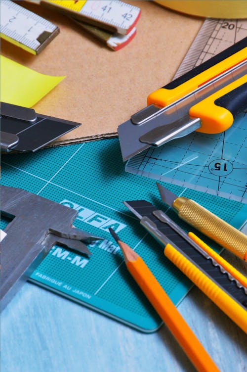 Close-up Photography Pencil and Cutters on Table