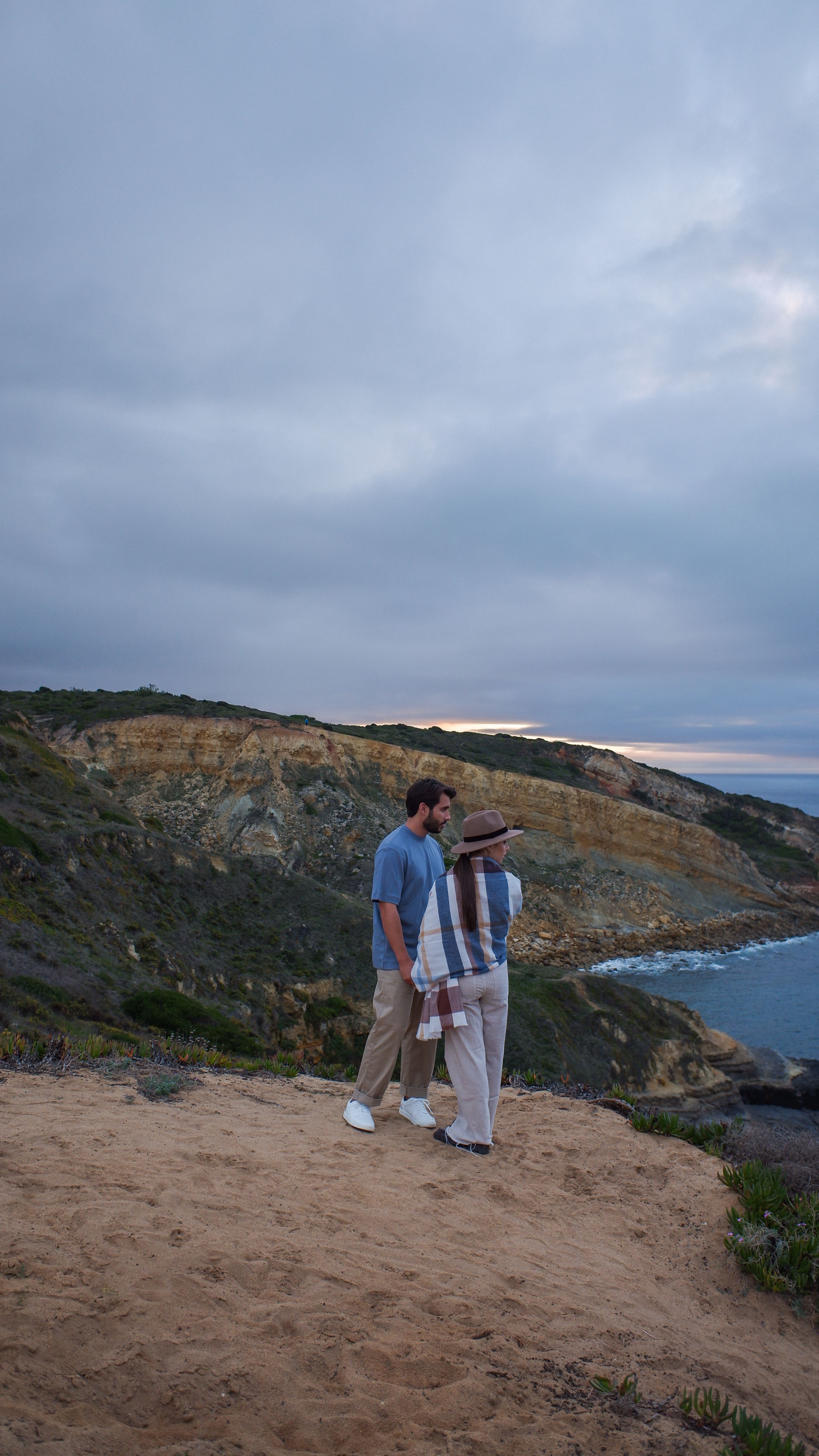 A Man and a Woman Standing on Brown Mountain · Free Stock Photo