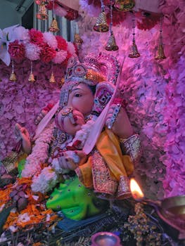 Colorful Ganesh idol adorned with flowers at a festival in Mumbai.