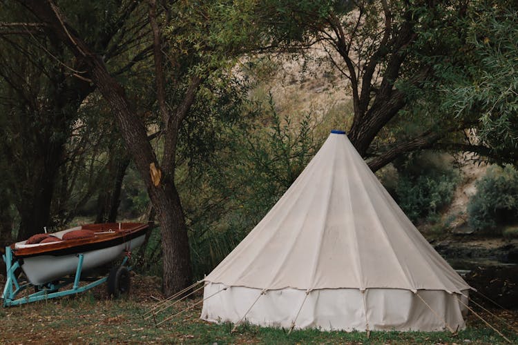 Tent And Boat On Camping In Forest