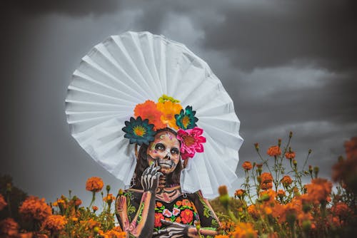 A Woman with Creative Makeup Standing in the Field