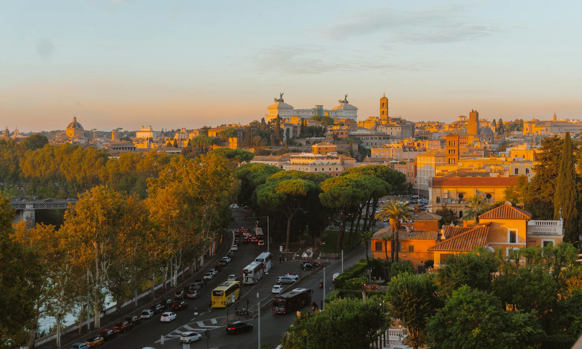 A breathtaking aerial view of Rome at sunset, showcasing iconic landmarks and vibrant city life.