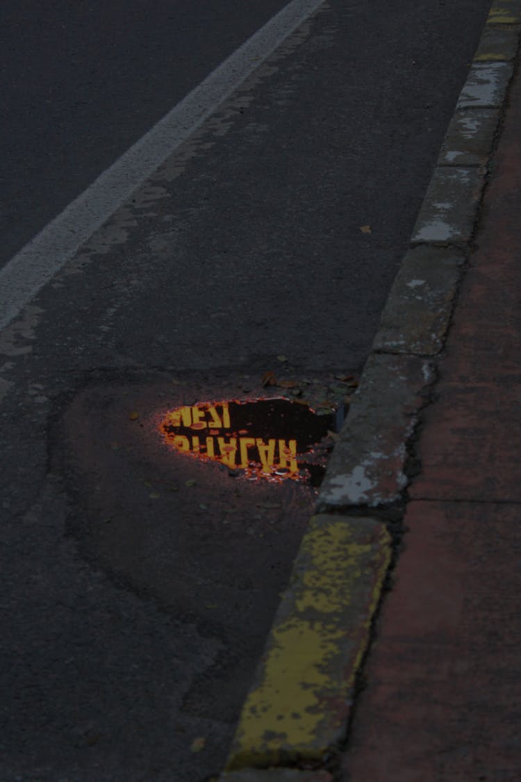 Puddle Of Water On Concrete Pavement