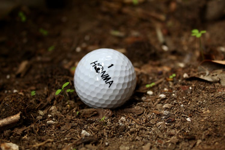 Close-up Shot Of A Golf Ball On The Ground