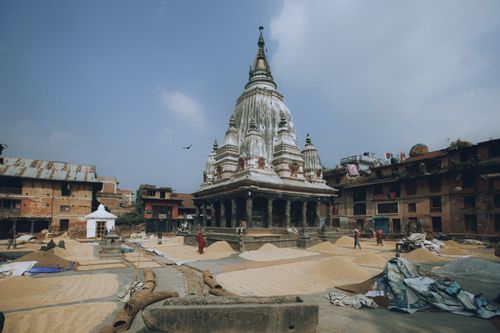 Free View of Bungamati Temple with historical architecture and traditional drying grains. Stock Photo