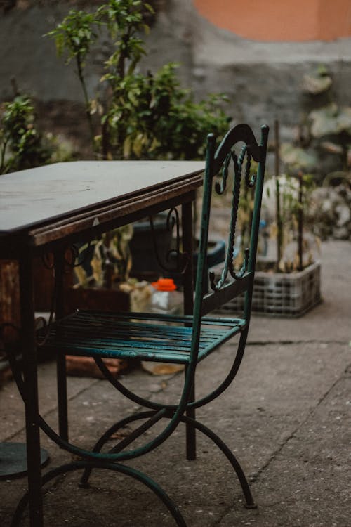 Table and a Chair Standing in the Yard