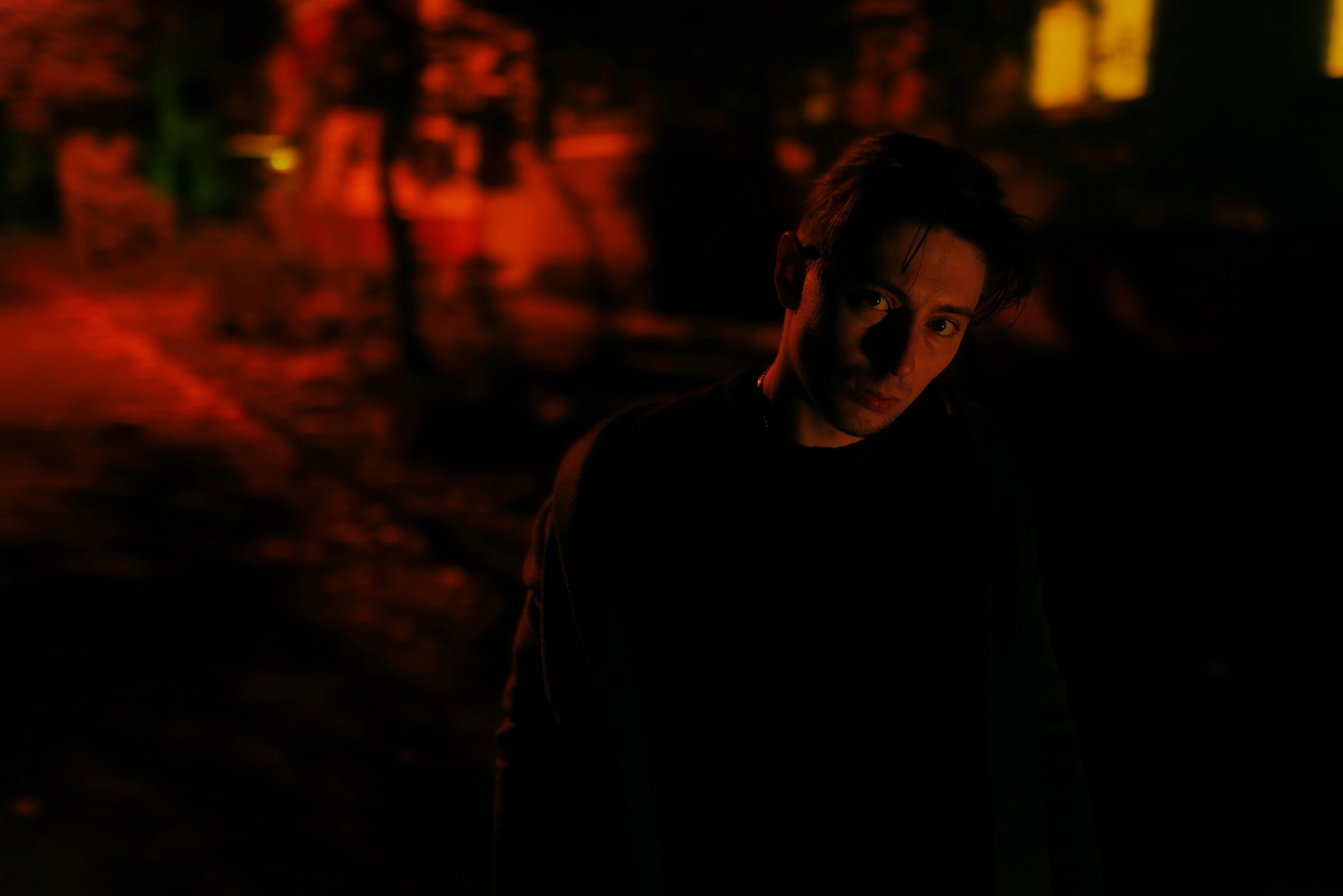 Person Sitting Alone In A Dimly Lit Room, Looking Contemplative And Isolated