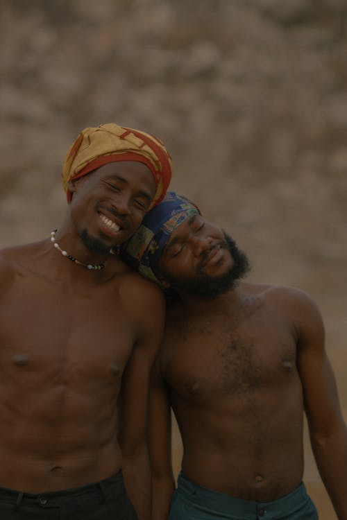 Topless Men With Headscarf Standing Beside Each Other Smiling 