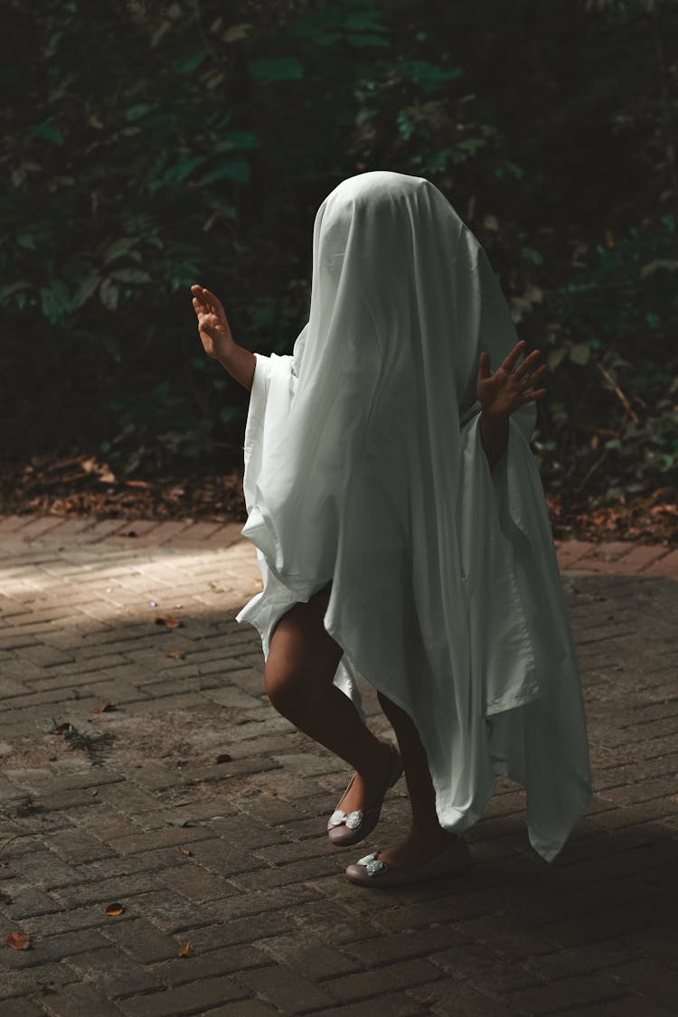 Woman Running With A White Sheet On The Head