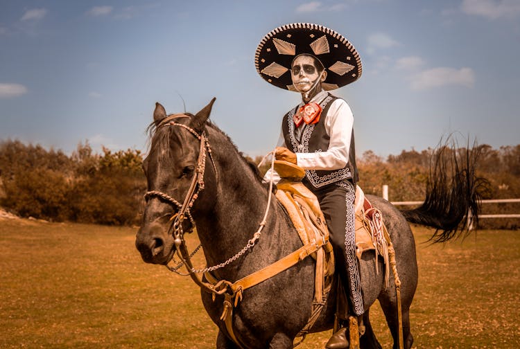 Man With Death Make Up Riding On A Horse