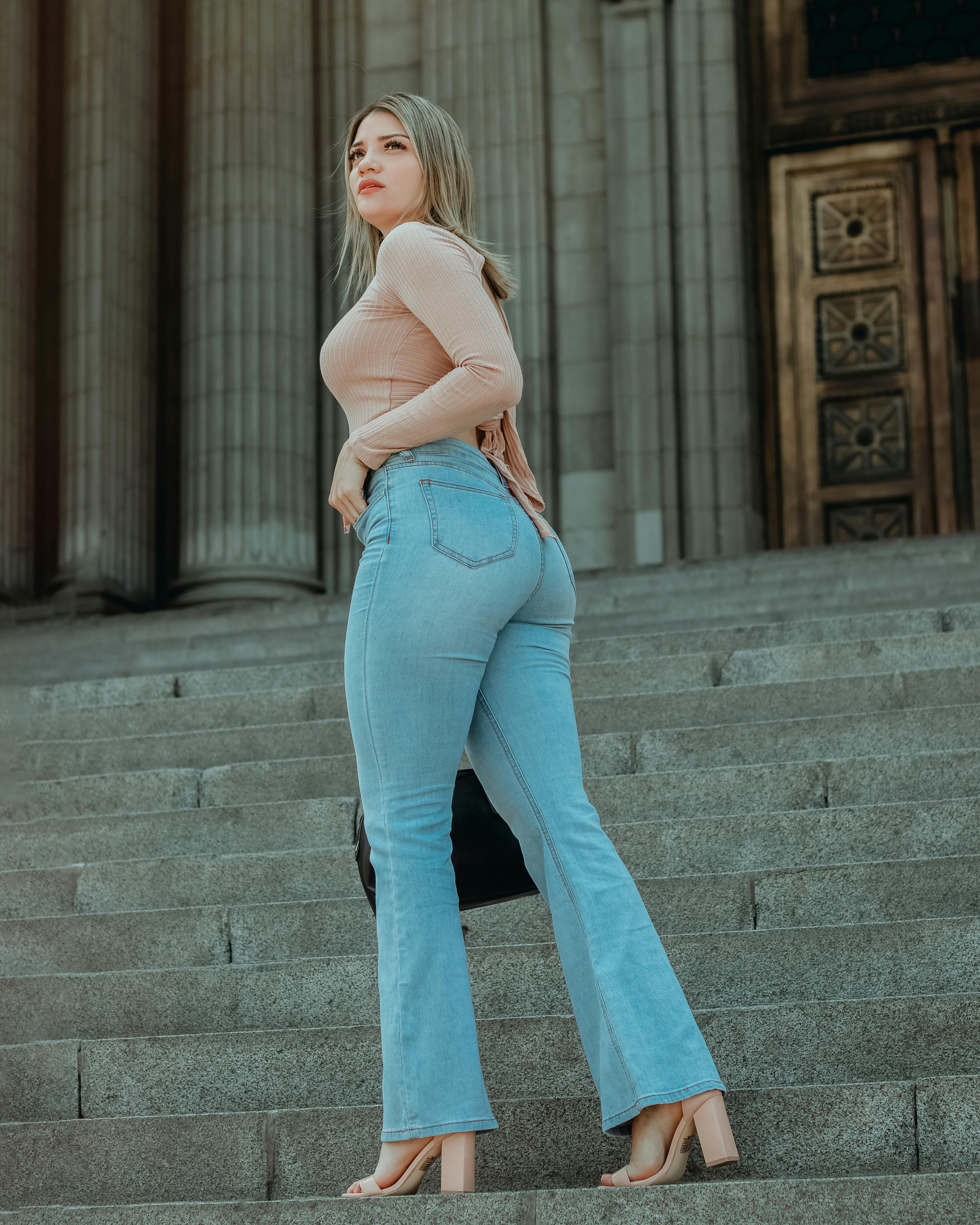 Woman in Blue Denim Jeans and Pink Long Sleeve Shirt · Free Stock Photo