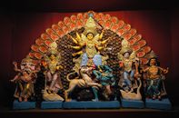 Intricately decorated Hindu deities at a Durga Puja altar in Kolkata, India.
