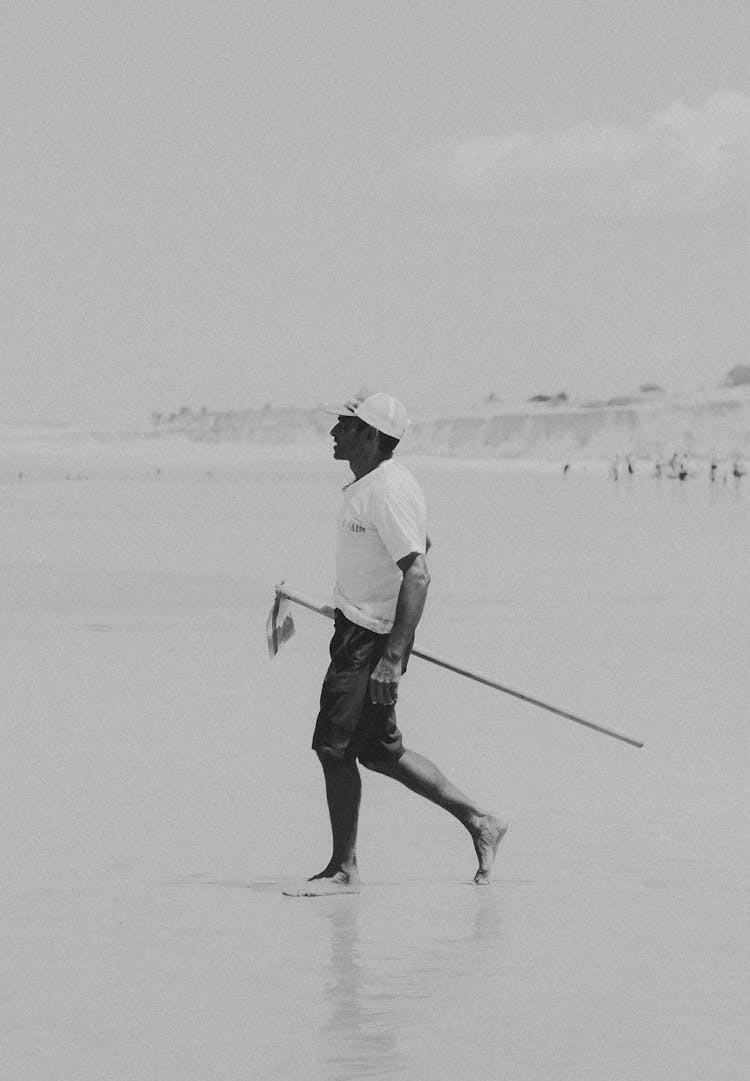 Man Walking On Sea Shore