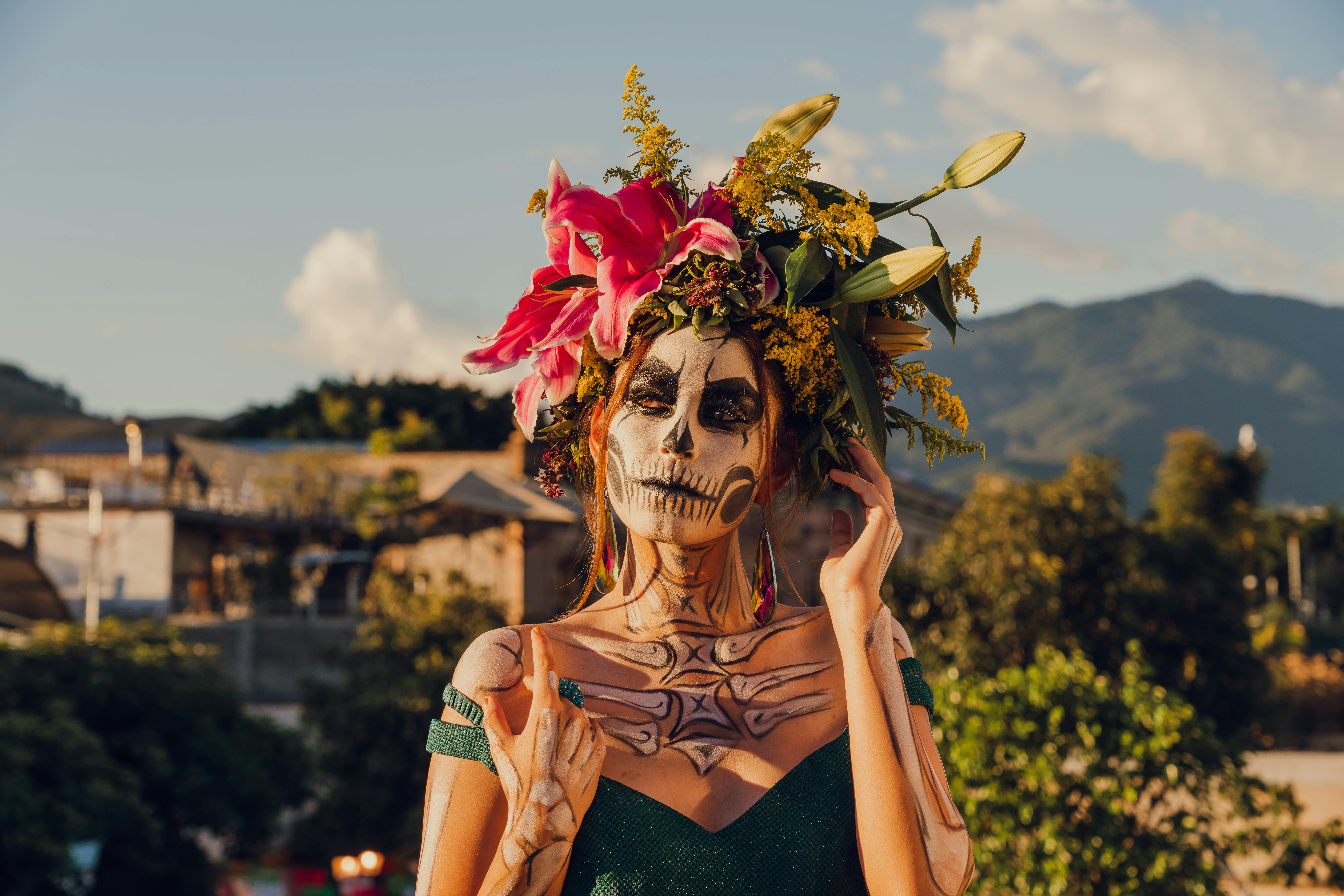 A woman with vibrant Dia de los Muertos makeup and floral headdress in Oaxaca, Mexico.