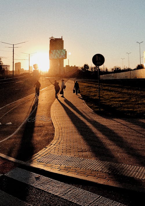 People Walking on the Road during Sunset