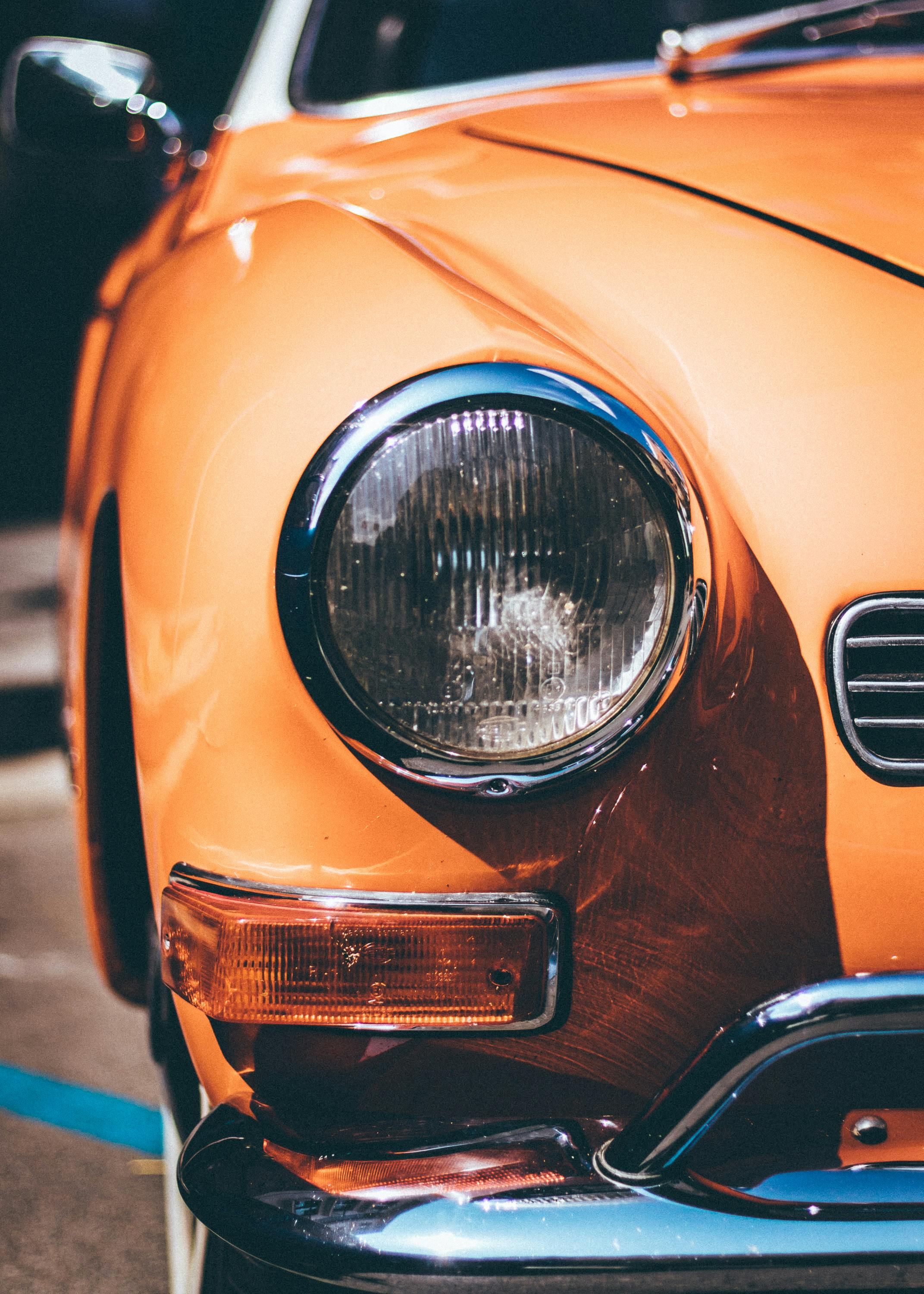 close up photography of orange vintage car