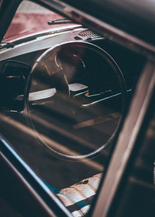 Free Artistic view of a vintage car's steering wheel and dashboard in Barcelona. Stock Photo