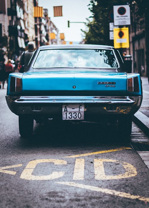 Close-up Photo of Blue Vehicle on Street