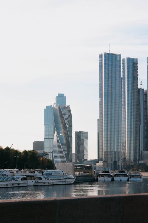 Free Moscow skyline view with skyscrapers and ferry boats in the harbor, featuring Evolution Tower. Stock Photo