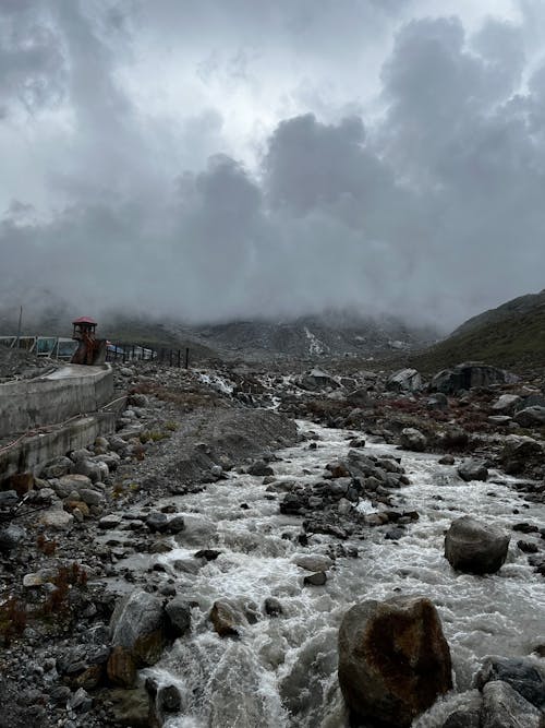 Free Photo of Rocky River under Cloudy Sky Stock Photo