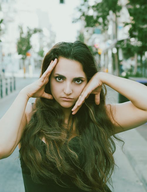 Portrait of a Woman Posing with Her Hands on Her Face