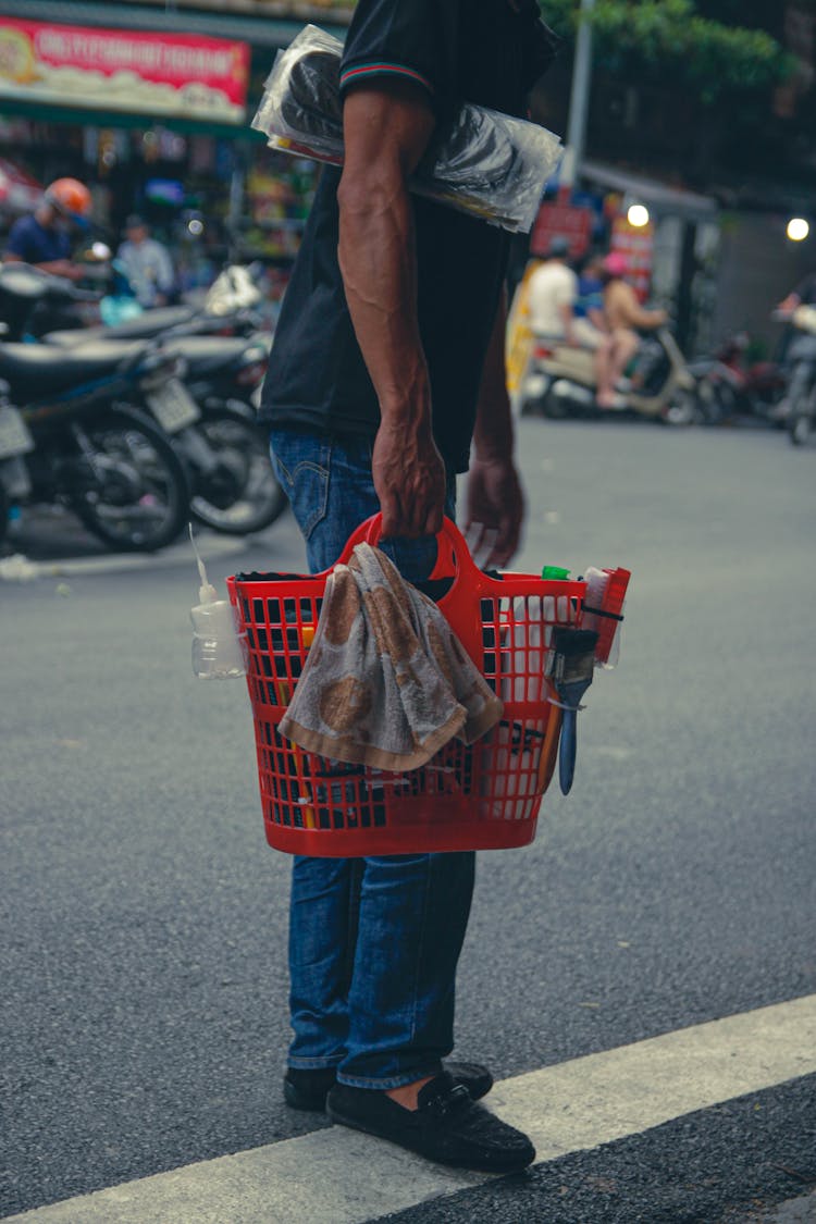 Photo Of A Man Carrying A Red Bag