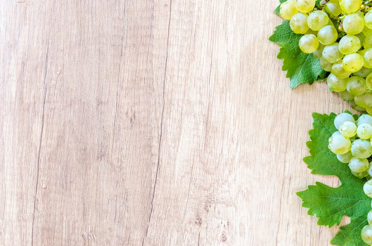 Green Grapes On Brown Wooden Panel