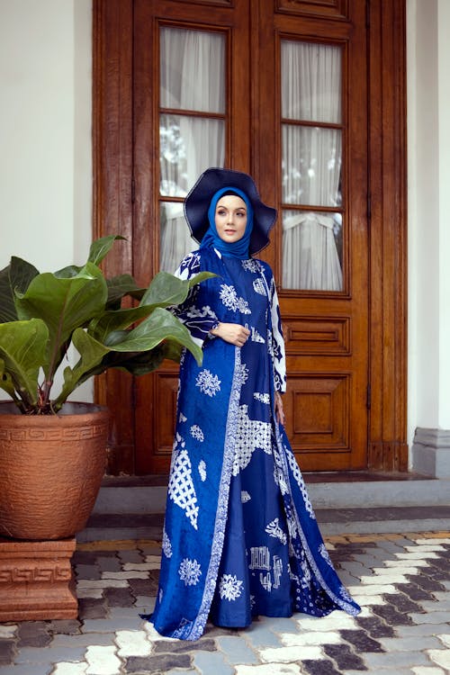 Woman Wearing Blue and White Traditional Clothing and Blue Hijab