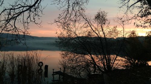 Free Tranquil view of a leafless lake at twilight, perfect for nature themes. Stock Photo