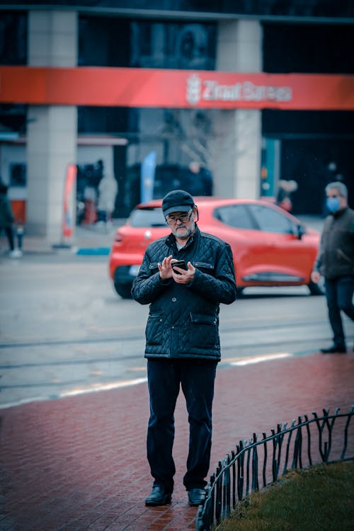 Photo of an Elderly Man Using His Phone