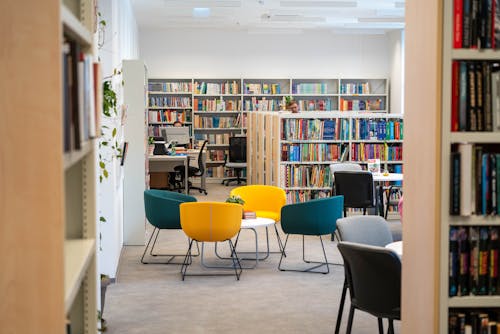 Photo of Chairs and Tables in a Library