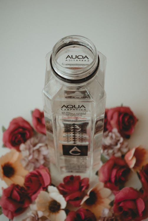 Aqua Bottle Surrounded by Flowers