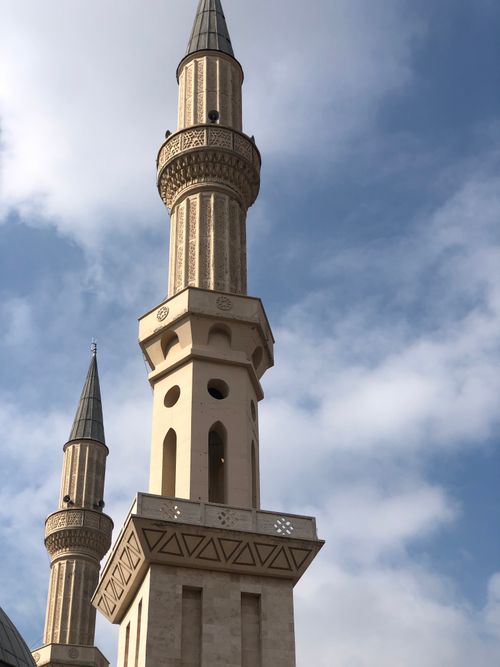 Free A close-up view of a beautifully designed minaret reaching into a clear blue sky. Stock Photo