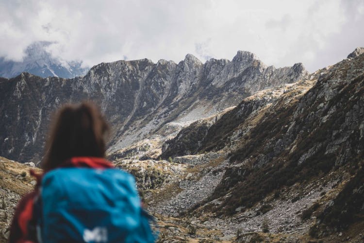 Woman With A Backpack In The Mountains