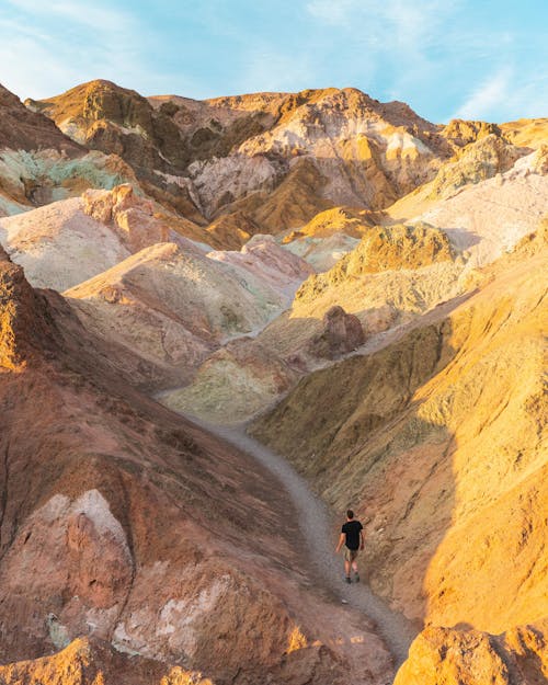 Man Hiking among Arid Hills