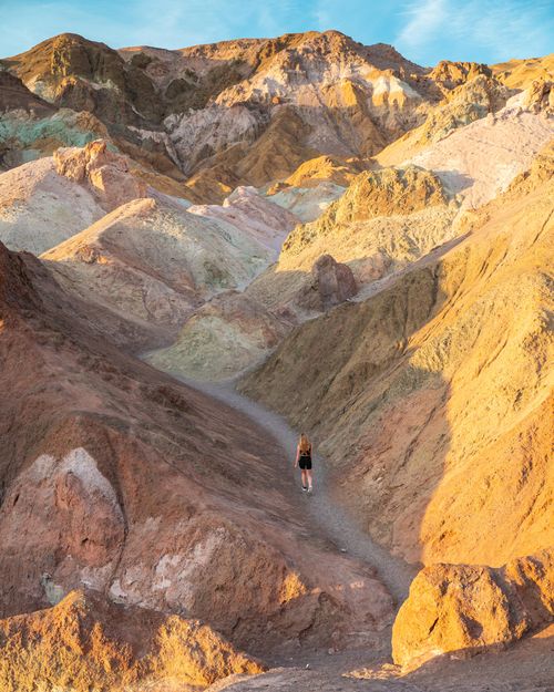 Free Hiker explores the vibrant geological formations in Death Valley, CA. Stock Photo