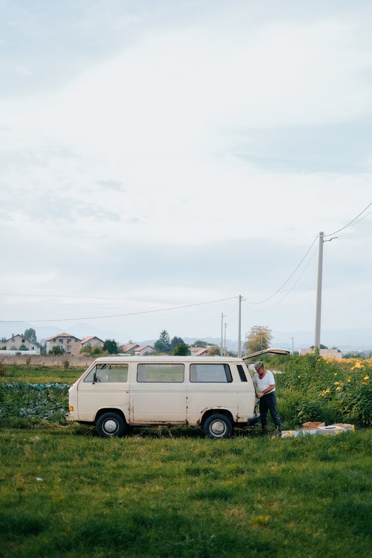 An Old Van In A Field